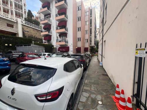 a white car parked on the side of a street at Hotel Principe in Sanremo