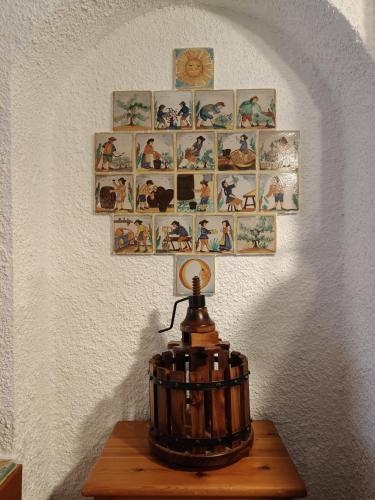 a cross on a wall with a lamp on a table at Casa rural entera en Parque Natural de los Puertos in Alfara de Carles