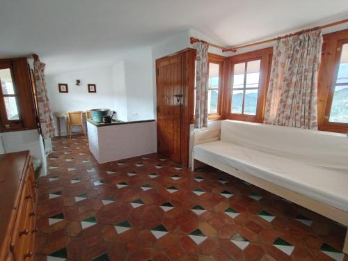 a room with a bench in the middle of a room at Casa rural entera en Parque Natural de los Puertos in Alfara de Carles
