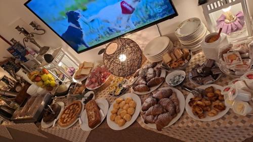 a table topped with plates of pastries and other food at Incanto Chic B&B nelle Scuderie in Sacrofano