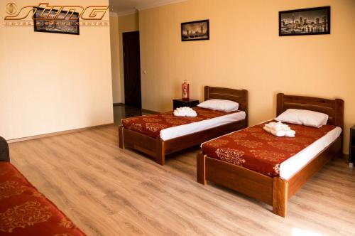 Postel nebo postele na pokoji v ubytování Sting Hotel & Event Palace