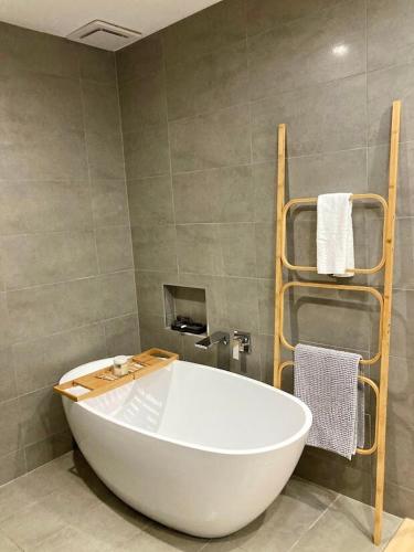 a large white bath tub in a bathroom at Sandy Feet Retreat - 50m from Four Mile Beach in Port Douglas
