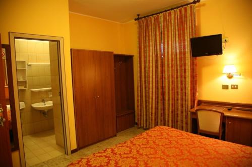Кровать или кровати в номере Hotel San Pellegrino