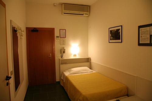 Кровать или кровати в номере Hotel San Pellegrino