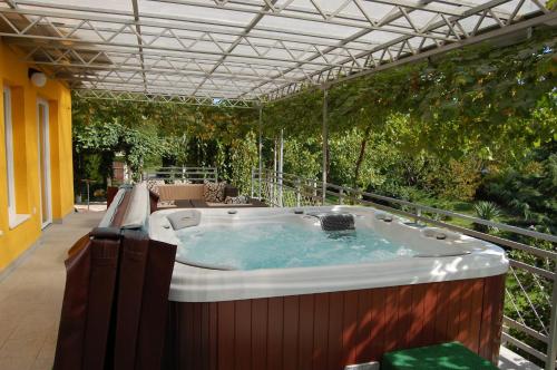 a hot tub in the middle of a patio at Judit Panzio in Gyulakeszi