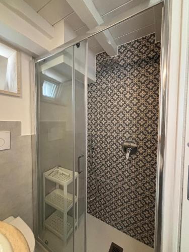 a shower in a bathroom with a glass door at Casetta Arco Casavola in Martina Franca