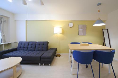 a living room with a couch and a table at ノーザンヒルズ南6条 in Sapporo