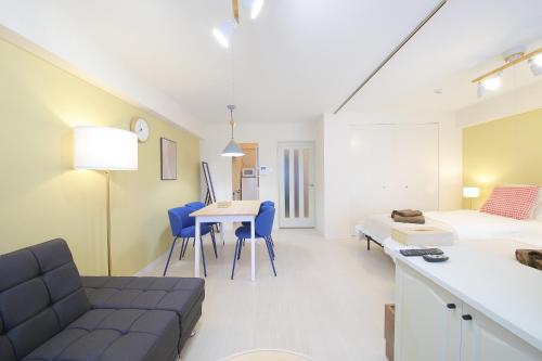 a room with a couch and a bed and a table at ノーザンヒルズ南6条 in Sapporo