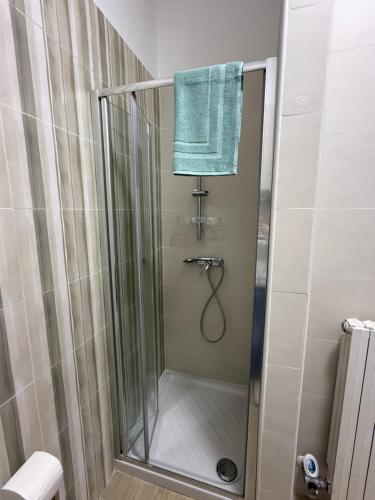 a bathroom with a shower with a blue towel at Casa Vacanze Nico in Lizzanello