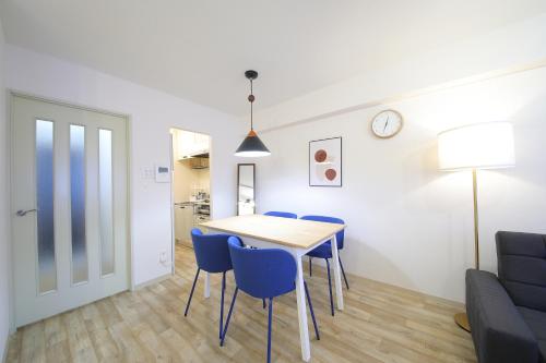 a dining room and living room with a table and chairs at ノーザンヒルズ南6条 in Sapporo