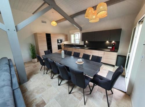 une salle à manger et une cuisine avec une table et des chaises dans l'établissement Belle villa familiale climatisée avec jardin clos, à La Teste-de-Buch