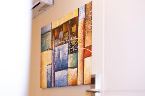 a painting hanging on a wall in a room at 4R Colombo Hotel in Tirana