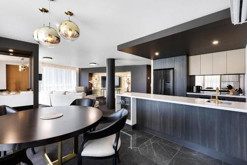 a kitchen and dining room with a table and chairs at Daydream Island Resort in Daydream Island