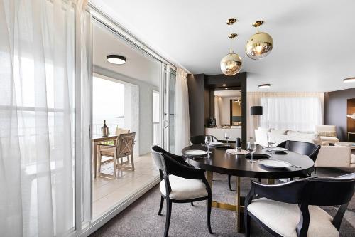 a dining room and living room with a table and chairs at Daydream Island Resort in Daydream Island