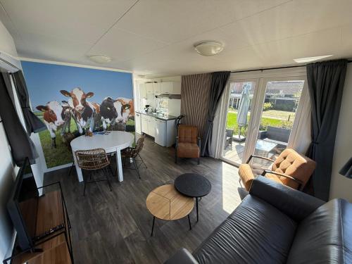 a living room with a couch and a table at Camping Wad noch Meer in Anna Paulowna