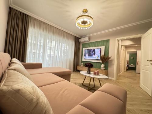 a living room with a couch and a table at Modern & Glam Apartments Evergreen Towers Underground Parking in Iaşi