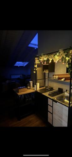 a kitchen with a sink and a counter with lights at Affittacamere Cà della Roggia in Rovereto