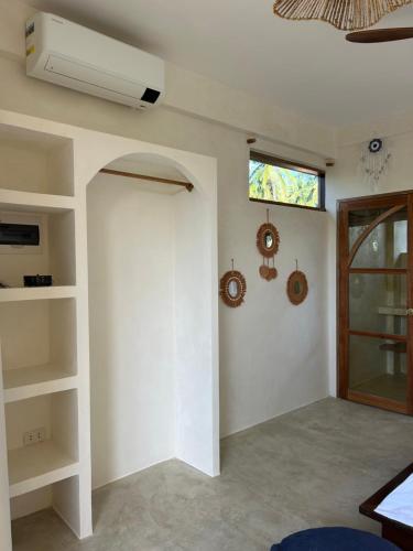 a living room with a white wall and a window at Jivanaya homestay in Libertad