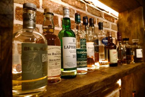 a bunch of bottles of alcohol sitting on a shelf at Black Horse in Brent Pelham