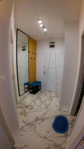 a hallway with a blue bench and a mirror at GoldenSands Apartments in Golden Sands