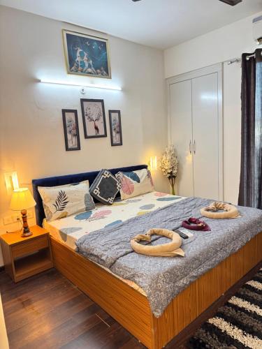 a bedroom with a bed with two oars on it at Harmony Heights By Royal Rooms in Noida