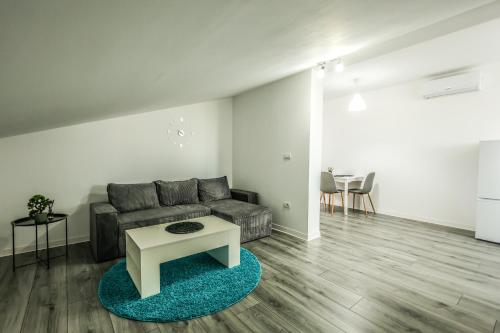 a living room with a couch and a table at Casa Chirila in Giarmata Vii