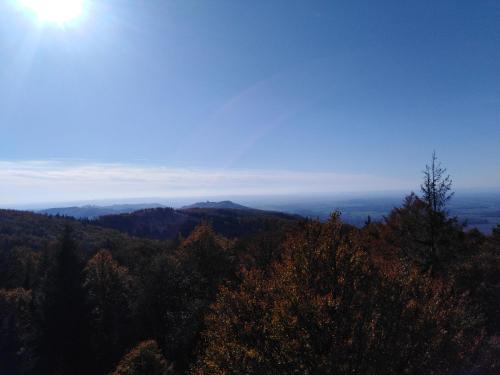 a view of a mountain with the sun in the sky at Chata Pod Kapličkou in Rajnochovice
