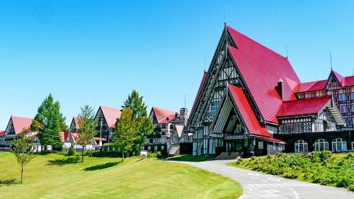 a large building with a large red roof at Hotel Green Plaza Joetsu in Minami Uonuma