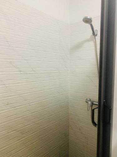 a shower with a shower head in a bathroom at Élégance et Sérénité Vue Mer Panoramique et Piscine Privée in Agadir