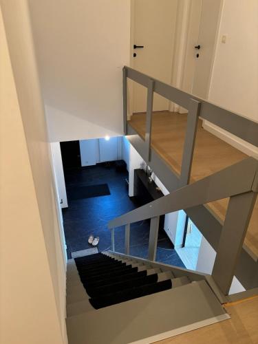 a view from the top of a stairs with a black rug at Cozy loft, nature & relaxation in Grimbergen in Grimbergen