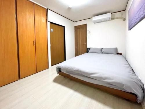 Postel nebo postele na pokoji v ubytování guesthouse Nakatsu