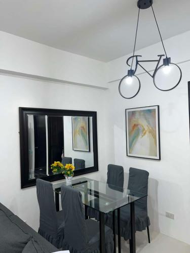 a dining room with a glass table and chairs at Bismillah - My Vacation Home in Baguio