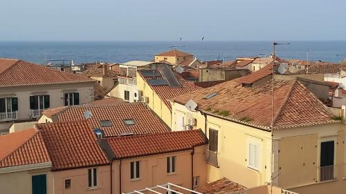 a view of roofs of houses and the ocean at Al vecchio castello in Tropea