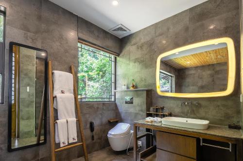 a bathroom with a sink and a toilet and a mirror at 南京又见江南民宿 in Nanjing