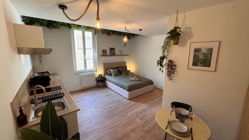 a living room with a couch and a table at Tropical Jungle in Béziers
