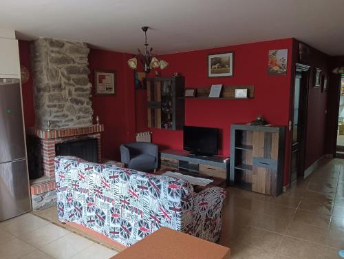 a living room with a couch and a fireplace at Casa el patio in Ampuero