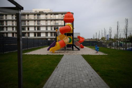 a playground with a slide in a park at TuWypoczywam - Apartament 58 1C Sianożęty z klimatyzacja i miejscem na dachu in Sianozety