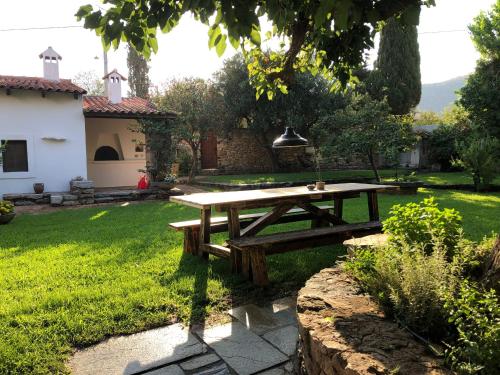 a picnic table in the yard of a house at Small Pool Villa at Marathon Greece in Marathón