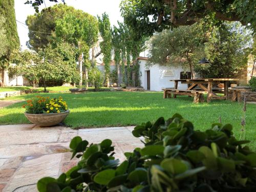 a garden with a picnic table and a bench at Small Pool Villa at Marathon Greece in Marathón