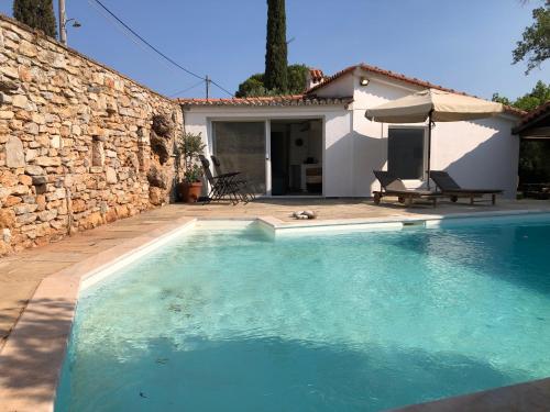 a swimming pool in front of a house at Small Pool Villa at Marathon Greece in Marathón