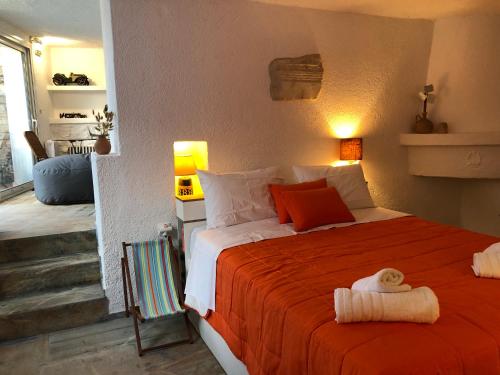 a bedroom with a large bed with an orange blanket at Small Pool Villa at Marathon Greece in Marathón