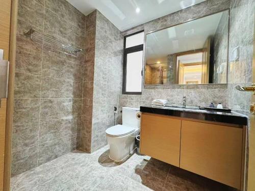 a bathroom with a toilet and a sink and a mirror at TheBess Hotel Tokyo is located adjacent to Singapore and offers a sea viewIt is a family business smart room with the sea view of Princess Bay富力公主湾 in Johor Bahru