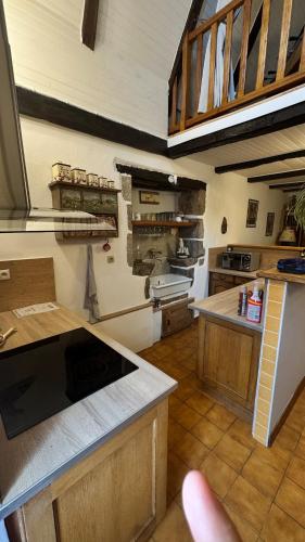 a large kitchen with a counter and a counter top at Gîte familial "La montagne des vaches" in Saint-Antoine
