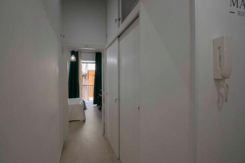a hallway with a phone in a white room at Massimo Rooms and suite in Palermo