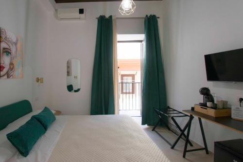 a bedroom with a bed and a window with green curtains at Massimo Rooms and suite in Palermo