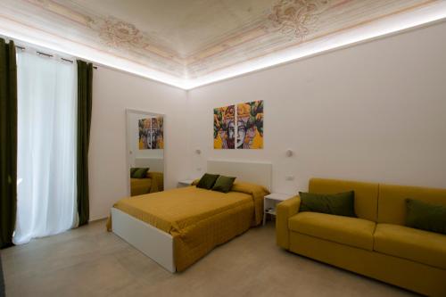 a bedroom with a bed and a couch at Massimo Rooms and suite in Palermo