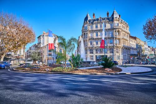 a street in a city with a large building at Tropical Jungle in Béziers