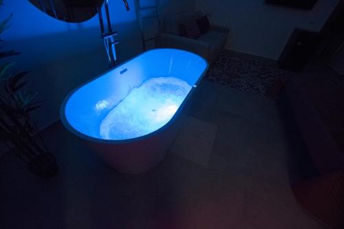 a blue bath tub in a dark room at Massimo Rooms and suite in Palermo