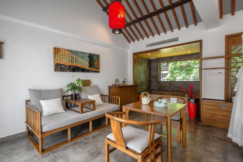 a living room with a couch and a table at 南京又见江南民宿 in Nanjing