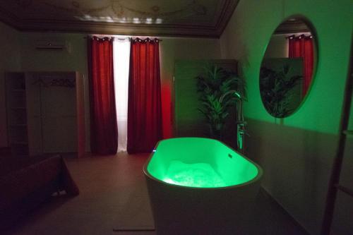a bathroom with a green tub in a room at Massimo Rooms and suite in Palermo
